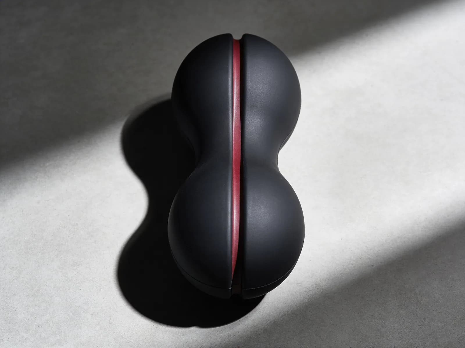 Peanut Ball — Double-lobed, solid rubber. Straddles the spine.